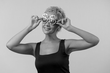 Close up shot of stylish a woman in sunglasses,she is smiling against black and white background. Beautiful female model with copy space.
