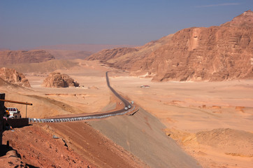 Fototapeta na wymiar The curved road in the red rocks in desert