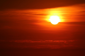 last light of sunset on the red cloud orange sky and ray around sun