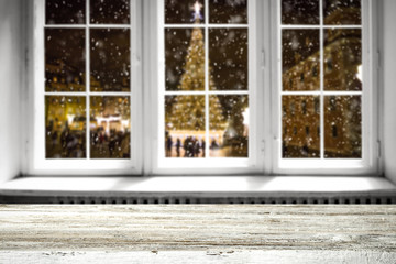 Table background and winter window with christmas tree 