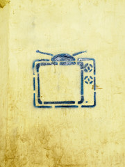 Blue TV on a yellow wall in colors flag of Ukraine in a sens of Russia's war against Ukraine.A...