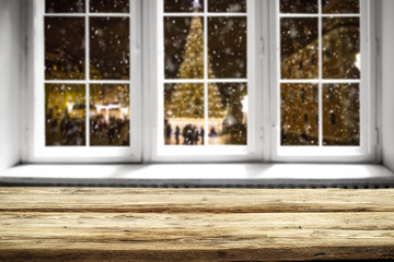 Table background and winter window with christmas tree 