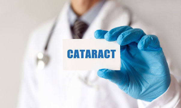 Doctor holding a card with text CATARACT, medical concept