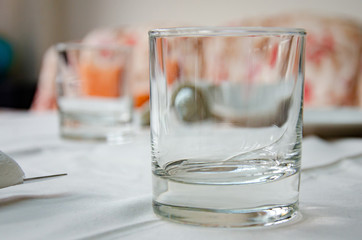A glass tumbler on a dining room table