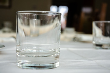 A glass tumbler on a dining room table