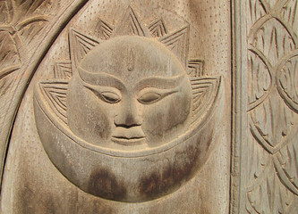 Fototapeta na wymiar Nepal. The wooden sun and moon in a door in Patan