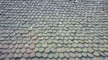 The surface and form of the roofing material are antique and tra