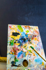 Art brush and palette with oil paints