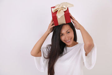 Smiling happy Asian woman holding red present box .New year, Christmas concept.