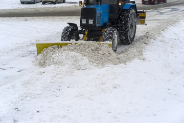 covered with snow, snow removal equipment on the streets to clean