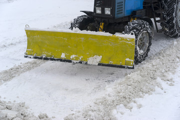 covered with snow, snow removal equipment on the streets to clean
