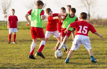 Zelfklevend Fotobehang Young children players on the football match © Dusan Kostic