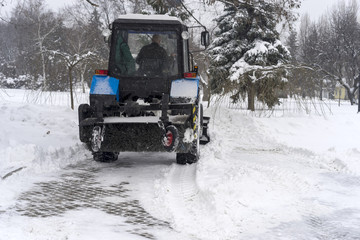 covered with snow, snow removal equipment on the streets to clean