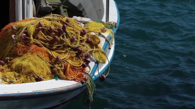 Close-up of fishing nets piled up on traditional Greek boat