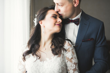 Cute happy bride and groom preparing for wedding