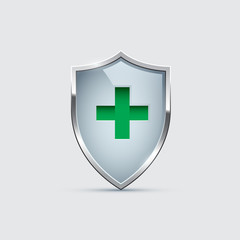 Obraz premium Glass Shield with silver frame and Green Cross isolated on gray. Vector Health Protection icon.