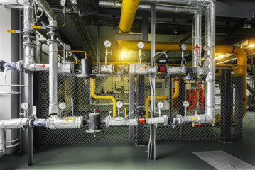 gas pipeline in yellow color with industrial high pressure gas gauge meters installed in the boiler...