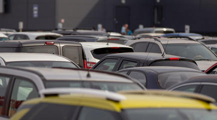 Many cars in the parking lot near the mall