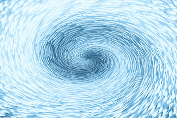 Blue wormhole in form of spiral absorbs space. Background image of asymmetric vortex tunnel in center of shot.