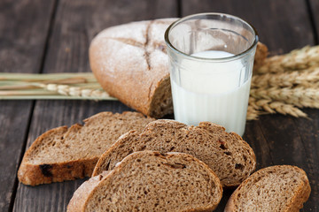 sliced bread with a glass of milk on a wooden table
