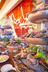 Tasty fresh oysters with flower decorate. Raw oysters are packed with nutrition, high in calcium, potassium, magnesium, vitamin and mineral. Flavor are sweet and refreshing. Believed to be aphrodisiac