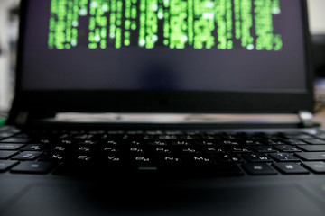 Caucasian hacker with code projection on his face in glasses