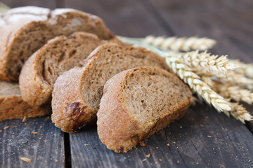 sliced bread with wheat ears on a wooden table