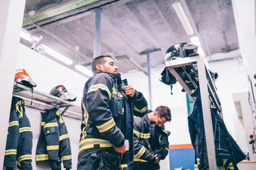 Firemen preparing for emergency service.
