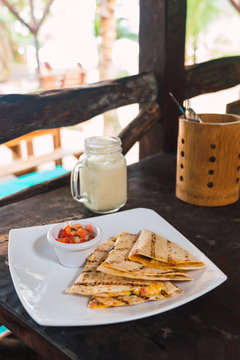 Served delicious quesadilla with salsa sauce
