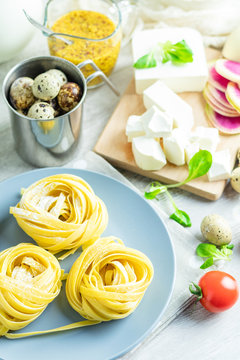 Raw homemade Italian typical pasta linguine noodles on plate