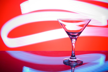 alcoholic glass in the club entourage, copy space, red background