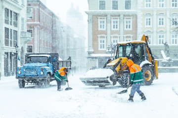 people cleaning city streets after snowstorm