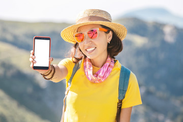 The cute girl traveler show an empty white phone screen