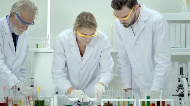 Male and female scientists conduct laboratory experiments.