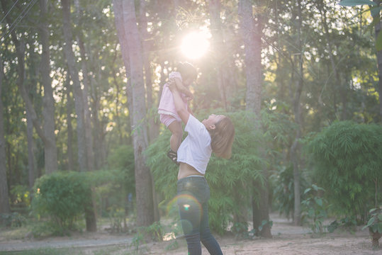 Beautiful Young Mother Play With Your Daughter With Fun At Playground With Flair Light,Happy Mother Day,Thailand People