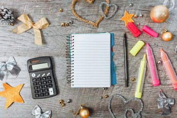 View from above. Christmas decoration with an open blank notepad, with a calculator and headphones, planning the new year.