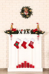 Christmas decorations with fireplace on brick wall background