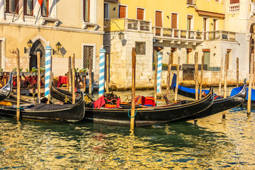 Fototapeta na wymiar Gondolas moored on the Grand Canal of Venice, Italy