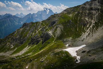 Valley in the Alps (Austria, Europe). Beautiful nature, high mountains, summer day, snowy peaks. Hike in the rocks, traveling with a backpack.