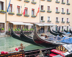 Fototapeta na wymiar VENICE, ITALY, NOV 1st 2018: Gondolas parked at Gondola Station Bacino Orseolo. Classic Venezia or Venice colorful cityscape