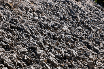 Scenic natural abstract background from texture of the mountain slope with stones.