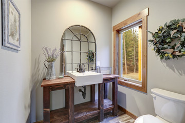 Fantastic bathroom boasts a country style wooden washstand