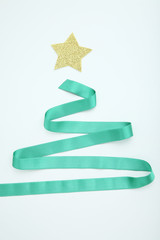 Green ribbon in shape of christmas tree on white background