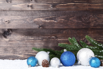 Christmas decorations with fir tree branches on wooden background