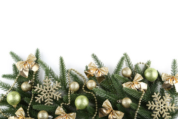 Christmas fir tree branches with decorations on white background