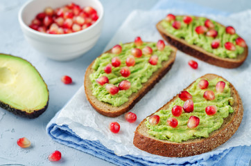 Smashed avocado pomegranate rye sandwiches