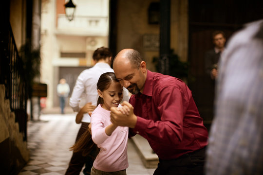 Side view of a man dancing with a girl.