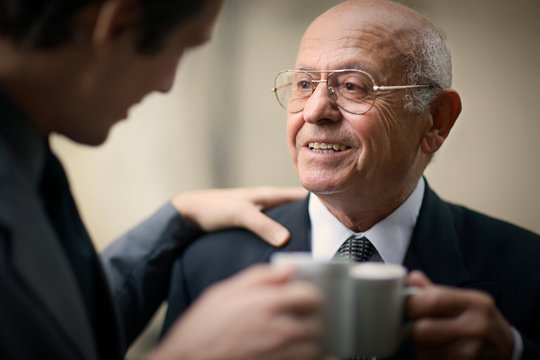 View of two men in a conversation.