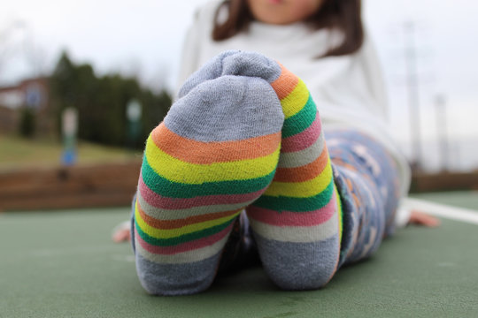 Girl's feet in striped socks Stock Photo | Adobe Stock