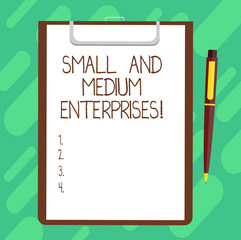 Conceptual hand writing showing Small And Medium Enterprises. Business photo text SME growth of startups new business analysisagement Sheet of Bond Paper on Clipboard with Ballpoint Pen Text Space